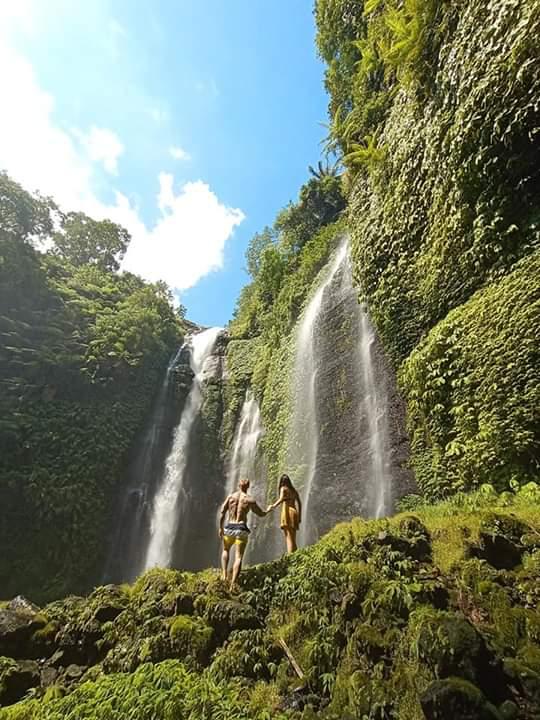 Bali Tour Sekumpul Waterfall surrounded by lush jungle