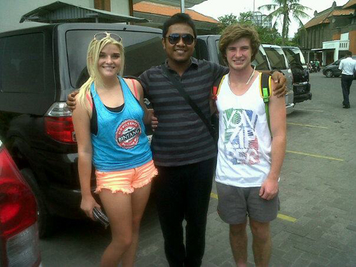 Friendly private driver greeting guests at a resort entrance for a Bali tour hotel pick up with Mr Bali Tour